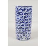 A Chinese black & white porcelain cylinder vase with bamboo forest decoration. 10" high x 5"