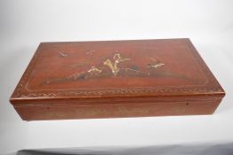 A Japanned and lacquered storage box with internal trays, signed inside the cover, 25" x 12" x 4½"