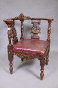 A C19th walnut corner chair with carved bow back, splats and shaped seat rails, the carving