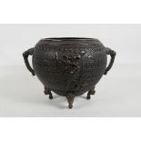 A Japanese Meiji period fine cast bronze censer/pot with two dragon mask handles and raised