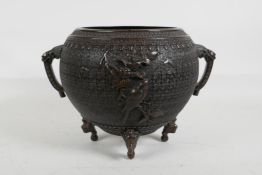 A Japanese Meiji period fine cast bronze censer/pot with two dragon mask handles and raised