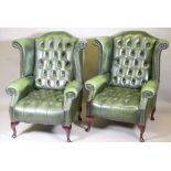 A pair of buttoned leather wingback armchairs, with brass stud detail, raised on cabriole supports