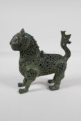 A Persian pierced bronze lion censer with verdigris patina, 7" high