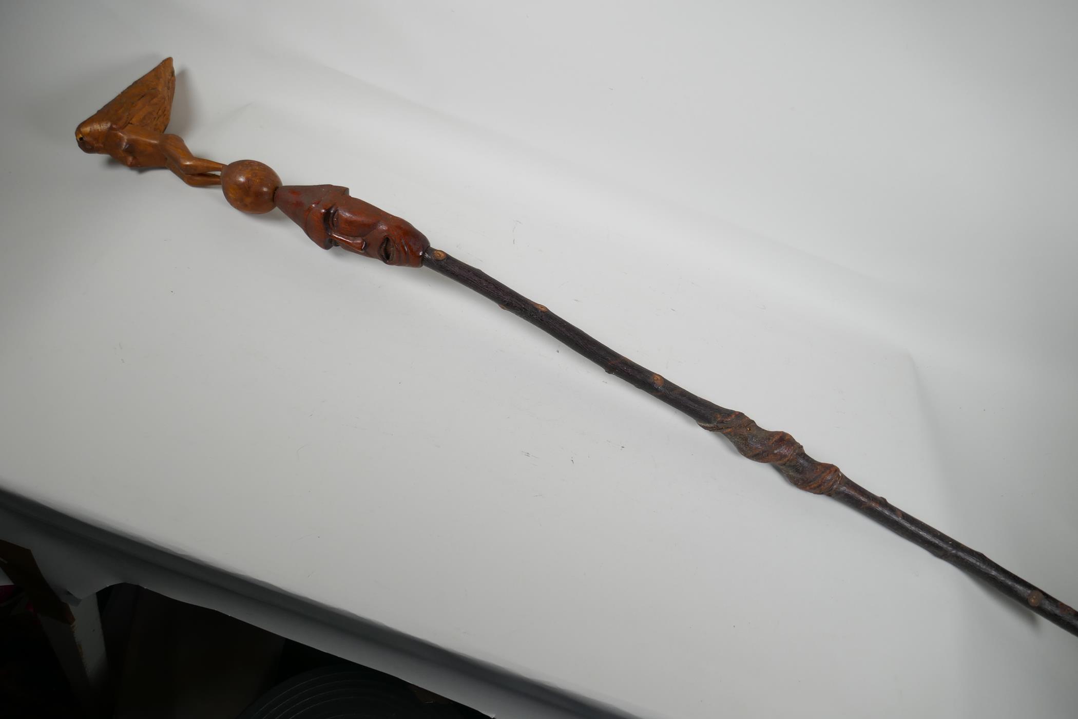 An African wood walking stick, with carved wood head with hedgerow shaft and later handle, 43" long
