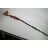 An African wood walking stick, with carved wood head with hedgerow shaft and later handle, 43" long