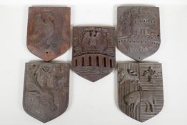 Five late C19th carved oak heraldic plaques, 9" x 7"