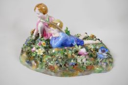 A Crown Staffordshire figurine of two children in a garden, modelled by T. Bayley, A/F, 12" long