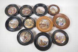 Eleven Prattware pot lids in turned wood frames, including "The Village Wedding", "Peace", and "That