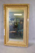 A large antique gilt framed wall mirror late, 43" x 21"