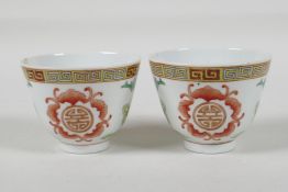 A pair of late C19th/early C20th polychrome porcelain tea bowls decorated with auspicious