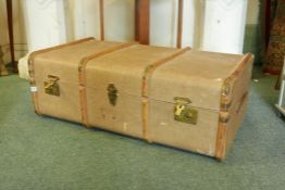 A vintage steamer trunk with beechwood straps and metal mounts, 36" x 20" x 13"