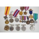A collection of medals commemorating various events and countries including WWI and II, a set of