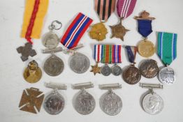 A collection of medals commemorating various events and countries including WWI and II, a set of