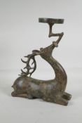 A Chinese archaic style bronze stand in the form of a stag, with character inscription to stand, 13"