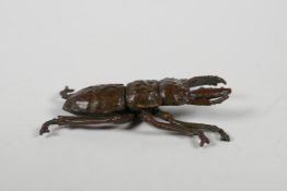 A Japenese Jizai style bronze stag beetle, indistinct mark to base, 2½" long