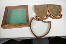 A small table top display case, 13" square, a shield  shaped frame and a pair of inlaid wooden