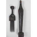 An African carved ebony figure at prayer, 13" high, and a carved wood ethnic comb, (Ivory coast)