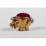 A coppered metal miniature pig pin cushion, 1" long