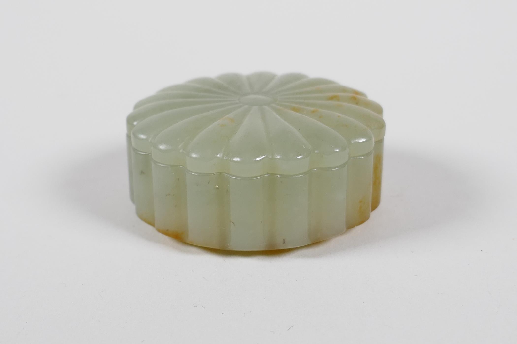 A Chinese carved celadon jade box and cover, 2" diameter