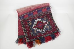 A Persian red & blue ground wool saddle bag, 35" x 16½"
