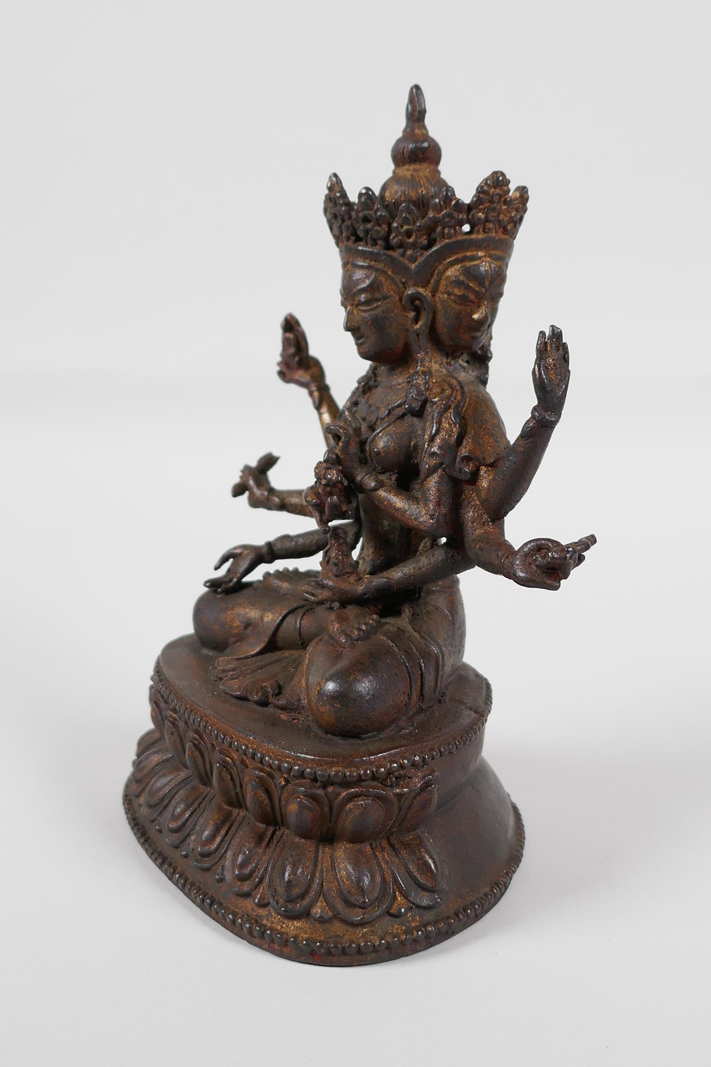 A Sino-Tibetan bronze of a many armed deity, seated on a lotus throne. Carrying auspicious items, - Image 2 of 4