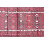 Hand woven full pile red and black ground Iranian Belouch rug, 50½" x 110"