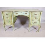A continental serpentine front kneehole desk, with seven drawers, painted green and decorated with