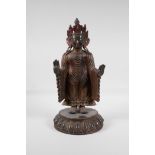 A Sino-Tibetan bronze Buddha on a lotus plinth, with remnants of gilt & lacquer patina