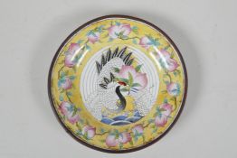 A yellow ground Canton enamel dish, decorated with a red crowned crane & peaches, Chinese, with