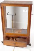 A rare "Westphal Balance", in mahogany and glass case, complete with instructions for use, 17½" high