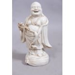 An antique Chinese blanc de chine figure of laughing Buddha, 8" high