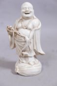 An antique Chinese blanc de chine figure of laughing Buddha, 8" high