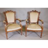 A pair of C19th French walnut show frame arm chairs in  the Grecian style with carved decoration,