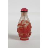 A Peking glass snuff bottle with carved pink carp and lotus flower decoration,