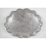 A large petal rimmed silver plated tray, engraved with many Eastern figures, 26½" x 20½"