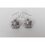 A pair of 925 silver owl earrings with ruby set eyes