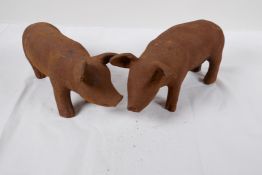 A pair of cast iron garden figures of piglets, 11" long