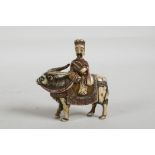 A C19th carved and stained bone snuff bottle in the form of a Chinese man riding a yak, 3" high