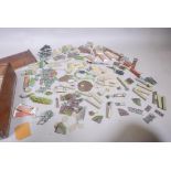 A quantity of Britains painted metal animals and toy garden accessories, in a wood box