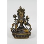 A Sino-Tibetan filled bronze of a deity seated on a lotus plinth, 8½" high