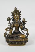 A Sino-Tibetan filled bronze of a deity seated on a lotus plinth, 8½" high