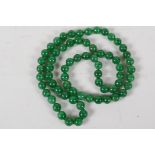 A long string of 67 jade beads, 33" long