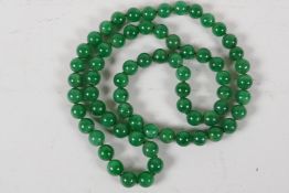 A long string of 67 jade beads, 33" long