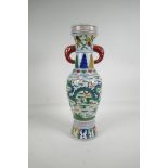 A Chinese Wucai porcelain, two handled vase of slender form, decorated with a red & green dragon,