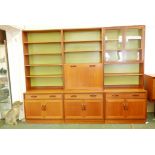 A mid century G-Plan teak Sierra wall cabinet comprising six modules, bases 33" x 18" x 27", upper