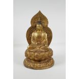 A Chinese filled gilt bronze figure of Buddha, seated on a lotus flower, impressed 4 character