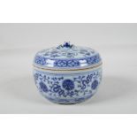 A Chinese blue and white porcelain cricket jar & pierced cover, with lotus flower decoration & an