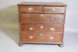 A late C17th/early C18th oak chest of two over three drawers, raised on squashed bun supports, 38" x
