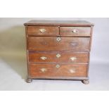 A late C17th/early C18th oak chest of two over three drawers, raised on squashed bun supports, 38" x