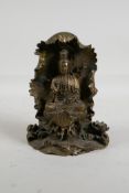 A Sino Tibetan bronze figure of Quan Yin, seated within a lotus flower, mark to the reverse